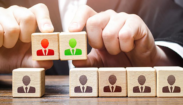 Businessman chooses a candidate for the team. Leadership and personnel management. Hiring qualified professional staff. Adapting to changes in leadership positions. Business team building.